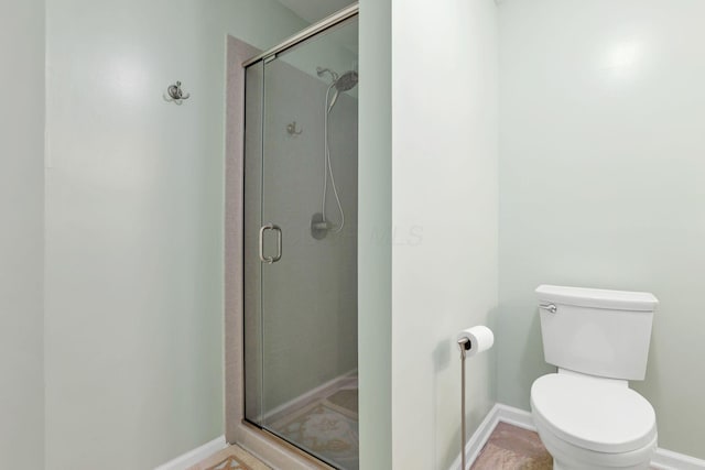 bathroom featuring toilet and walk in shower