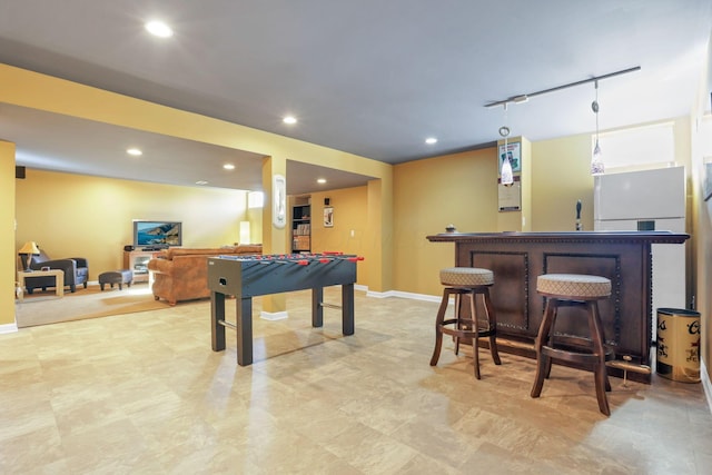 game room with track lighting and indoor bar