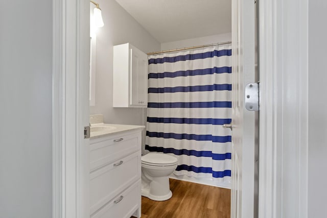 bathroom featuring a shower with shower curtain, vanity, toilet, and hardwood / wood-style floors