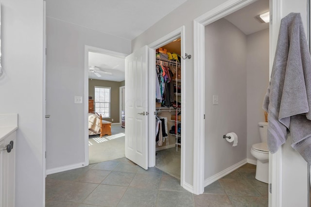 bathroom featuring vanity, tile patterned floors, and toilet