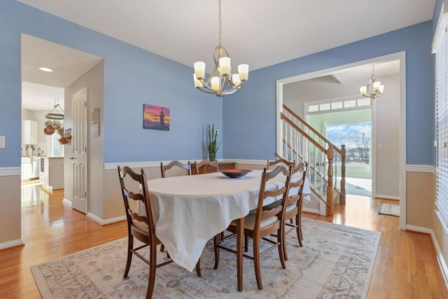 dining space featuring a notable chandelier and light hardwood / wood-style floors