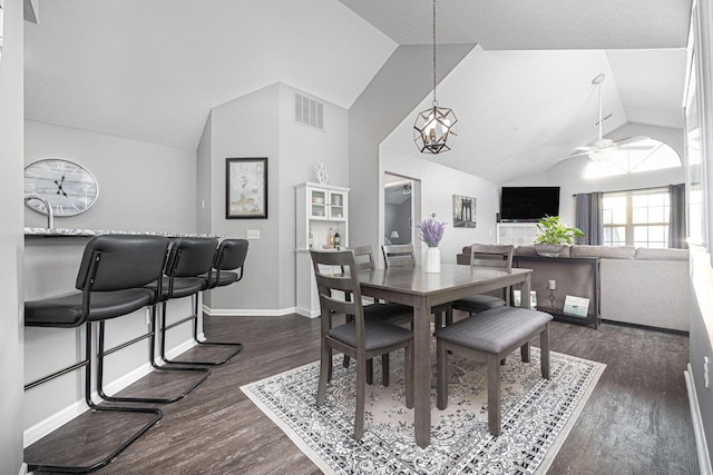 dining area with vaulted ceiling, dark hardwood / wood-style floors, and ceiling fan with notable chandelier