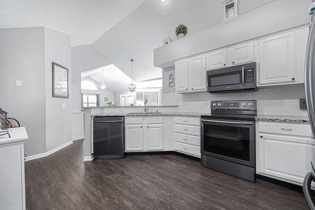 kitchen featuring appliances with stainless steel finishes, lofted ceiling, sink, white cabinets, and kitchen peninsula