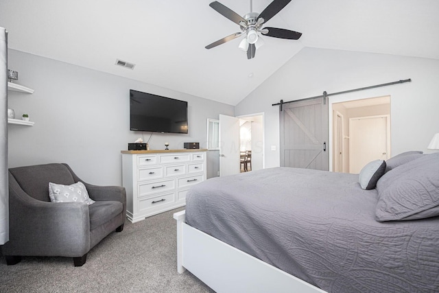 bedroom with light carpet, vaulted ceiling, a barn door, and ceiling fan