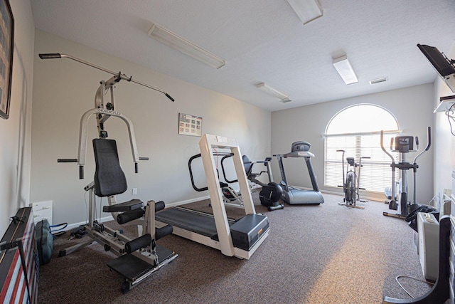 workout area with a textured ceiling