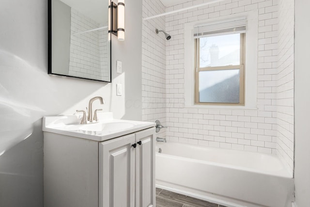 bathroom with vanity and tiled shower / bath combo