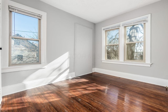 unfurnished room featuring dark hardwood / wood-style flooring