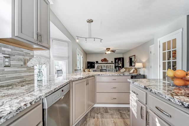 kitchen featuring ceiling fan, dishwasher, light stone countertops, decorative backsplash, and light wood-type flooring