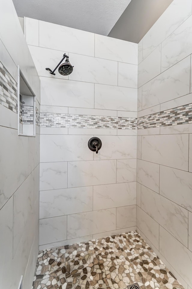 bathroom with a tile shower