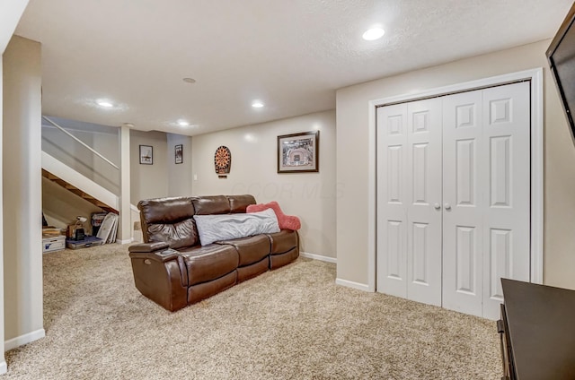 carpeted living room featuring a textured ceiling