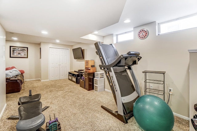 exercise area featuring light colored carpet