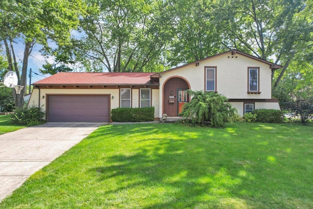 view of front of house featuring a garage and a front lawn