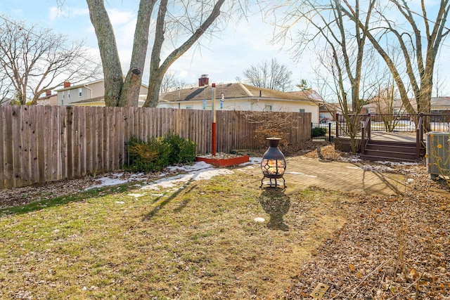 view of yard with an outdoor fire pit and a deck