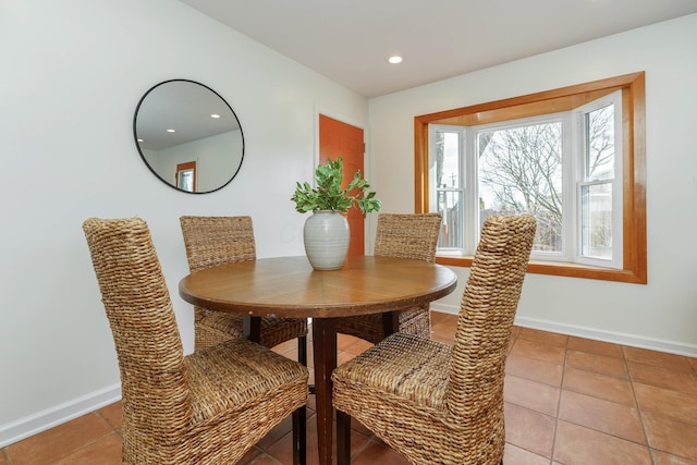 dining space featuring light tile patterned flooring