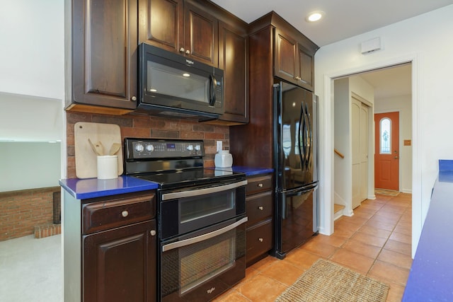 kitchen featuring tasteful backsplash, dark brown cabinetry, light tile patterned floors, and black appliances