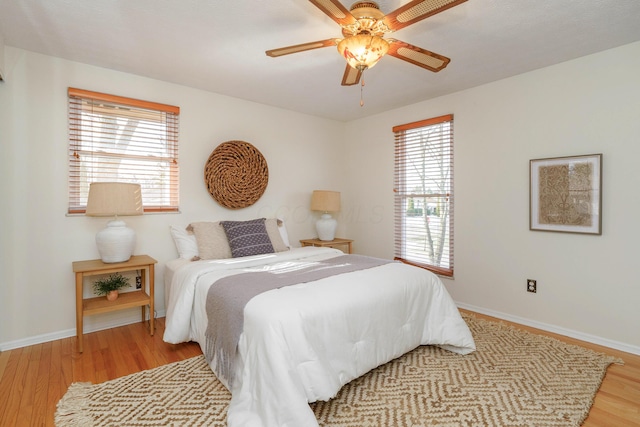 bedroom with light hardwood / wood-style floors and ceiling fan