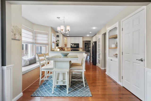 dining room featuring dark hardwood / wood-style floors and a chandelier