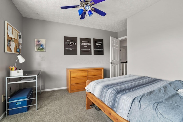 carpeted bedroom with ceiling fan and a textured ceiling