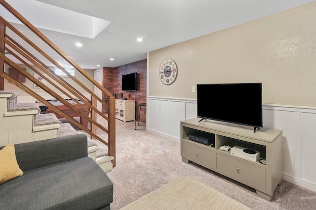 carpeted living room with a skylight