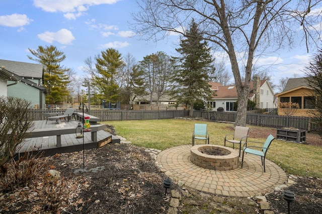 view of yard featuring a deck and a fire pit