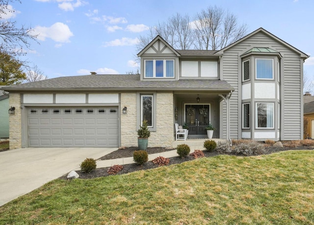 view of front of property with a garage and a front lawn