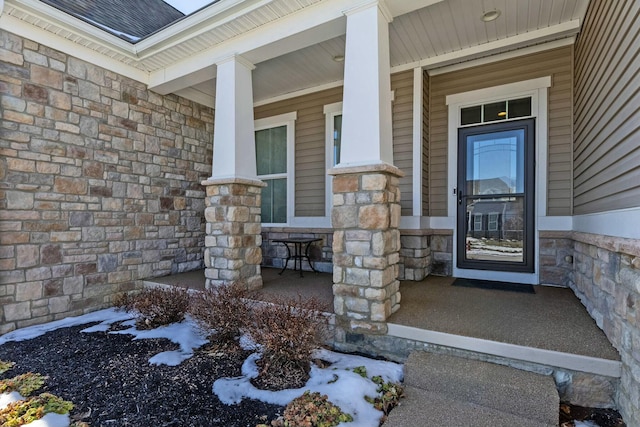 entrance to property featuring covered porch