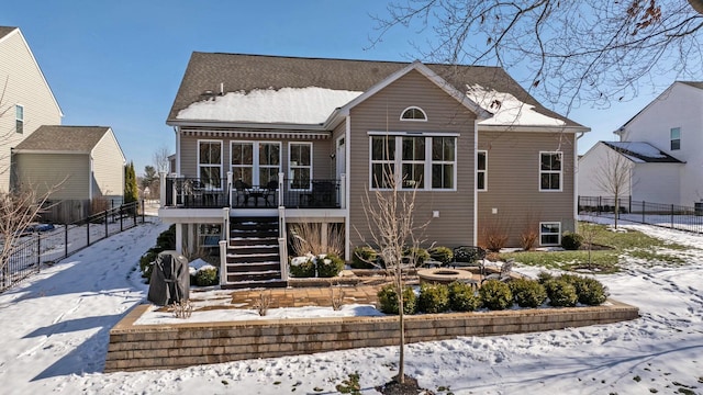 view of snow covered back of property