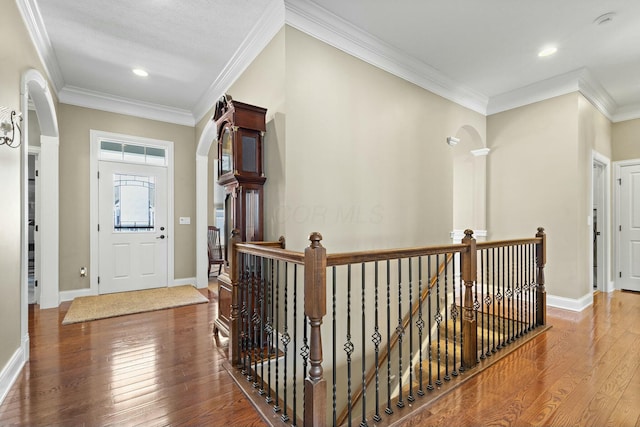 entryway featuring crown molding and hardwood / wood-style floors