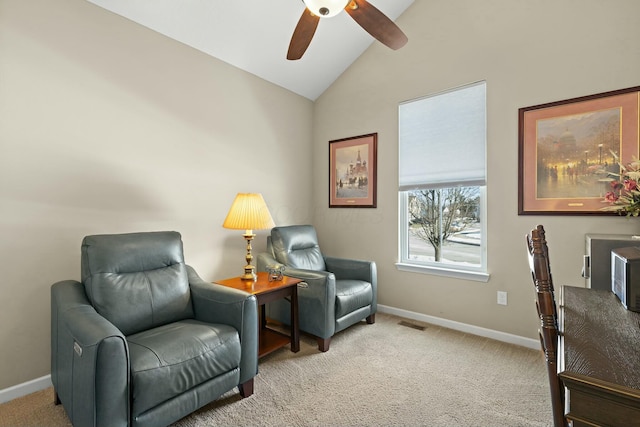 living area with ceiling fan, lofted ceiling, and light carpet