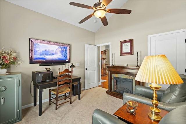 carpeted living room with ceiling fan, a premium fireplace, and high vaulted ceiling