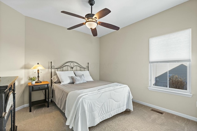 bedroom with ceiling fan and light carpet