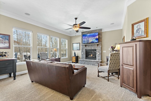 living room featuring ornamental molding, light colored carpet, ceiling fan, and a fireplace