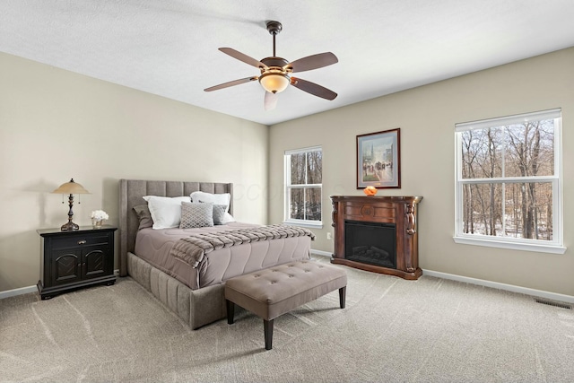 bedroom featuring light colored carpet and ceiling fan