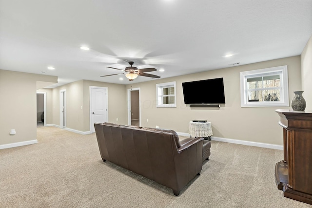 carpeted living room with ceiling fan