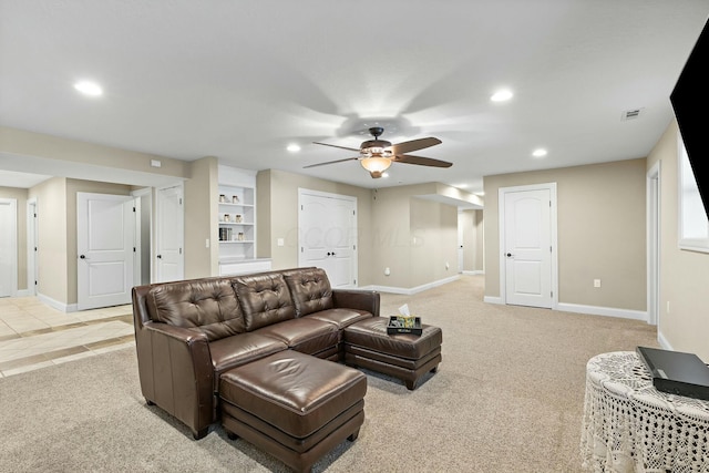 carpeted living room featuring ceiling fan