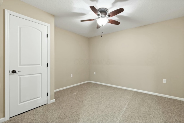 empty room featuring ceiling fan and carpet flooring