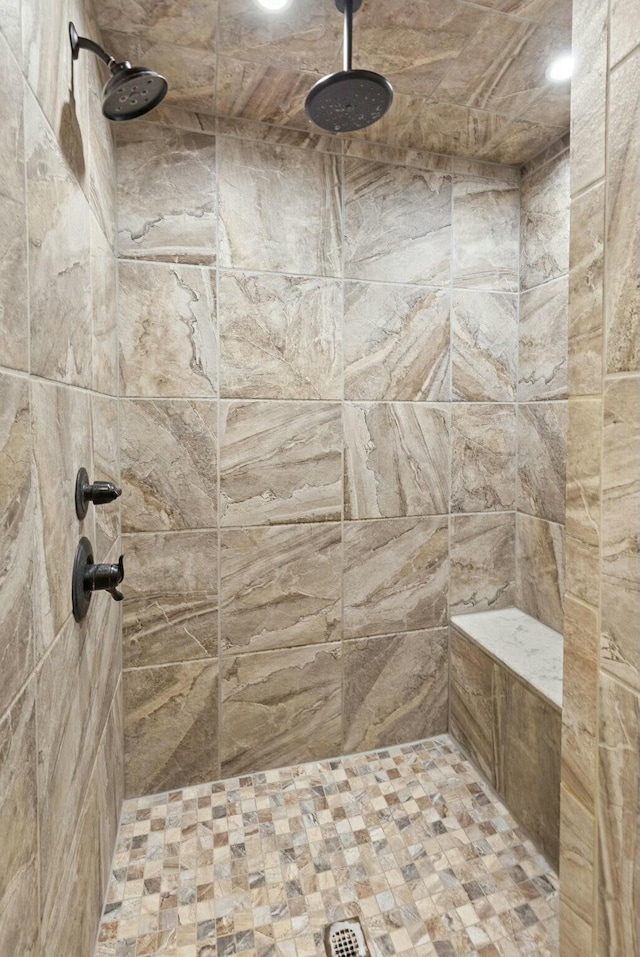 bathroom with a tile shower