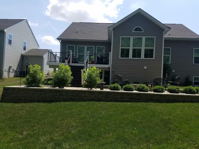 rear view of property featuring a lawn