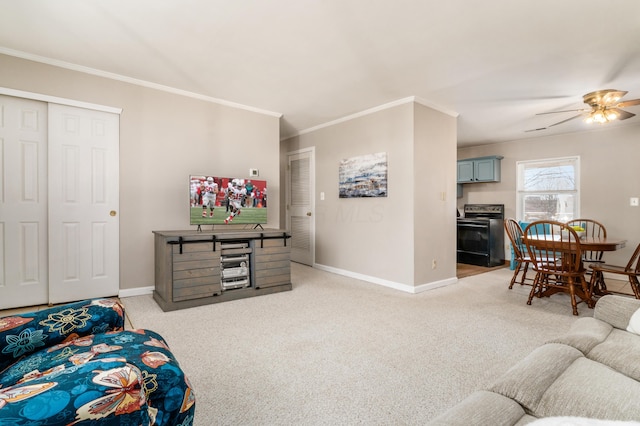 carpeted living room featuring ornamental molding and ceiling fan