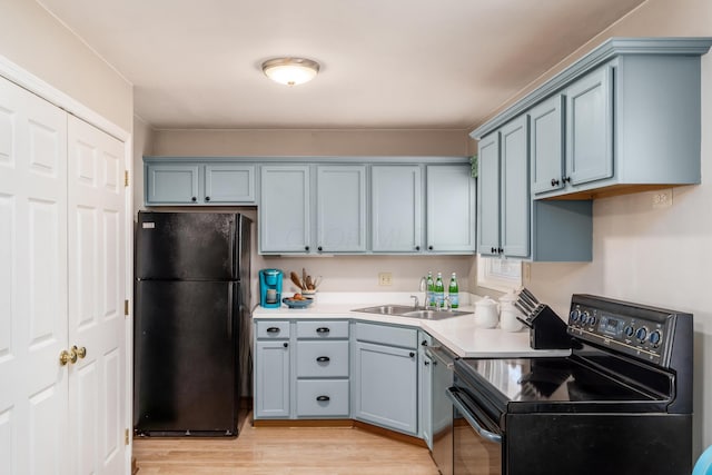 kitchen with sink, light wood-type flooring, and black appliances