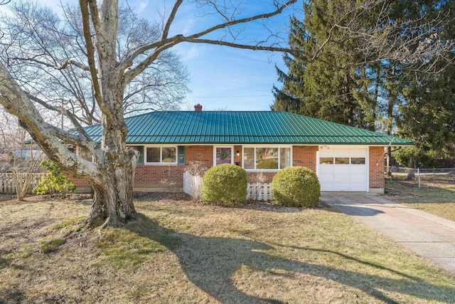 view of front of property featuring a garage and a front lawn