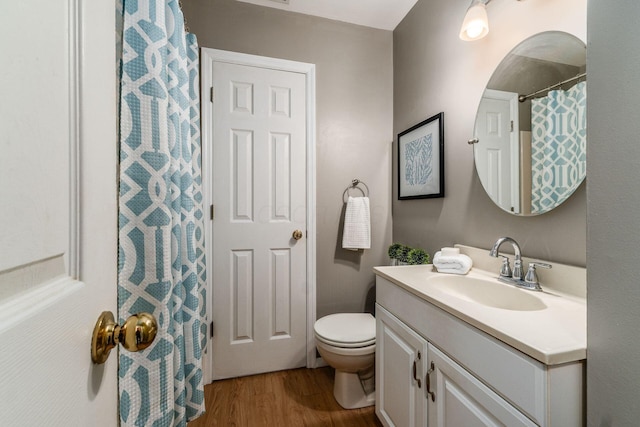 bathroom featuring hardwood / wood-style flooring, vanity, and toilet