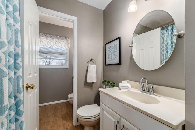 bathroom with vanity, hardwood / wood-style floors, and toilet