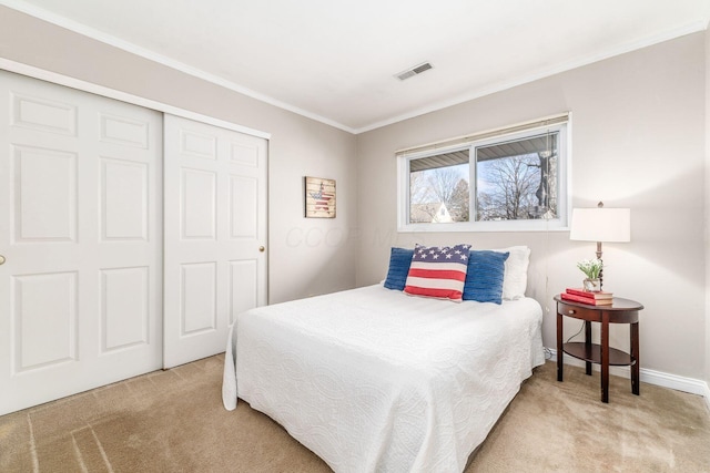 carpeted bedroom with crown molding and a closet