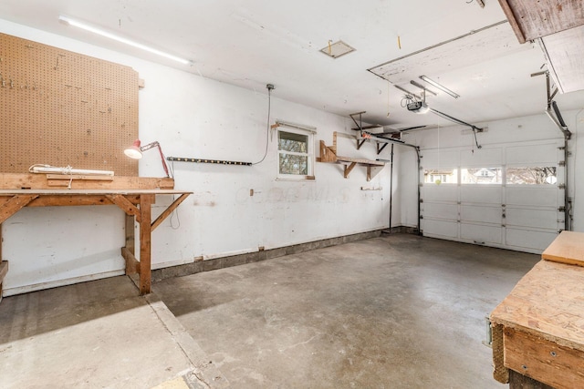 garage featuring a garage door opener and a workshop area