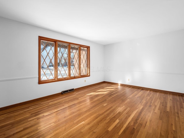 empty room with wood-type flooring