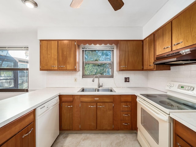 kitchen with tasteful backsplash, ceiling fan, sink, and white appliances