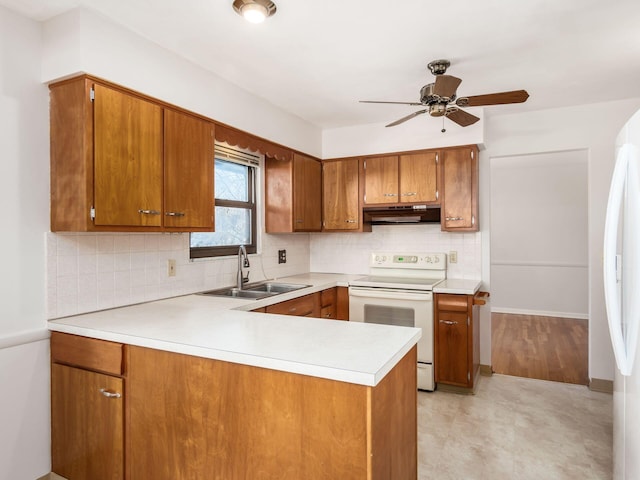 kitchen with sink, white appliances, kitchen peninsula, ceiling fan, and decorative backsplash