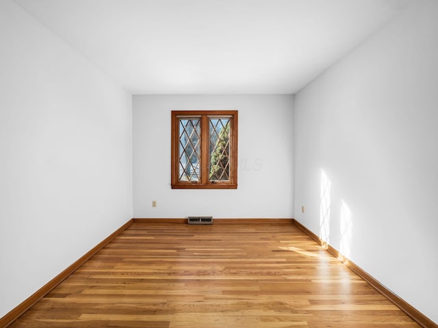 spare room featuring light hardwood / wood-style flooring