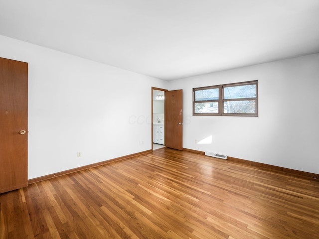 spare room featuring light hardwood / wood-style floors